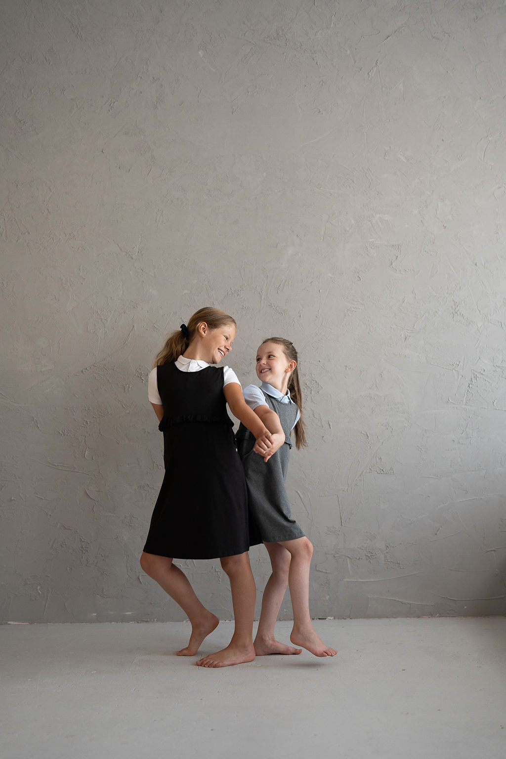 Girls’ black pinafore with ruffle