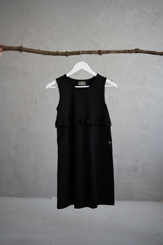 Girls’ black pinafore with ruffle