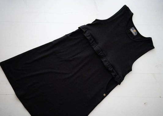 Girls’ black pinafore with ruffle