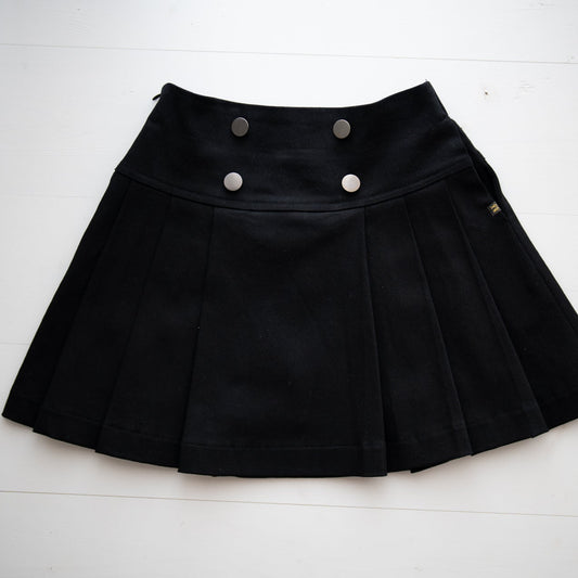 Black pleated skirt with button details on a white background